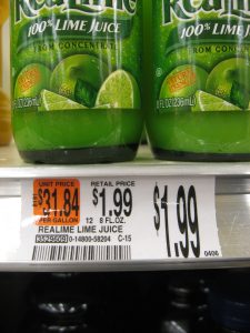 A shelf label at a grocery store showing product name (ReaLime lime juice), amount (8 fl oz), item price ($1.99), and unit price ($31.84 per gallon).]