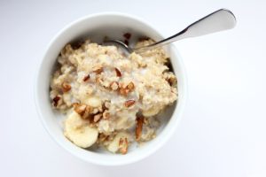 Oatmeal with milk, nuts, and bananas.