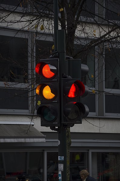 A traffic light showing yellow and red lights.