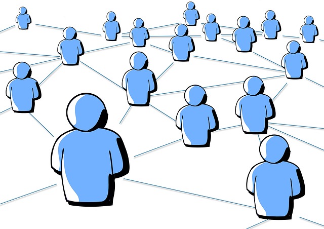 A graphic illustration depicting a network of interconnected people. The image features multiple blue, stylized human figures, each connected to others by thin lines, forming a web-like pattern. The figures are uniformly shaped and evenly spaced, representing the concept of social networks or interconnected communities. The background is white, keeping the focus on the connections between the figures.
