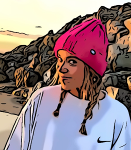 Student author portrait with art effect depicting a young woman with a fuchsia beanie on her head, pigtail braids and light brown hair, in a white Nike sweatshirt with a beach with large rocks behind her as she gives a friendly smirk.