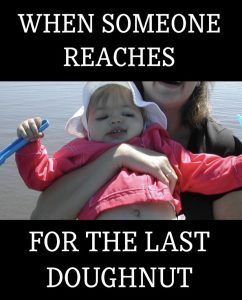 Meme of a toddler being held by an adult, with a plastic shovel in its hand and the words &quot;when someone reaches for the last doughnut&quot;.