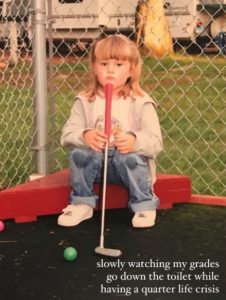 A meme depicting a little girl sitting down holding her put-put golf club, ball resting nearby, looking off into the distance with the words " slowly watching my grades go down the toilet while having a quarter life crisis".