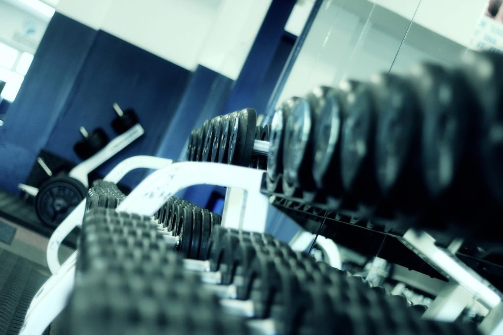 Racks of free weights stacked in a gym