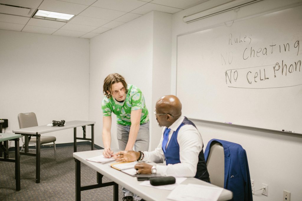Student talking to his teacher.