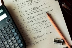 Calculator laying on page of math equations