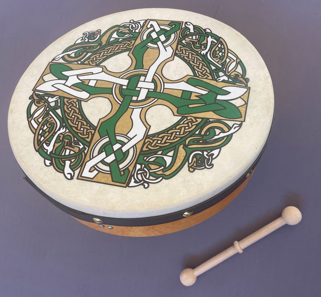 Irish frame drum with a beater. The drum has a celtic design on the front of it.