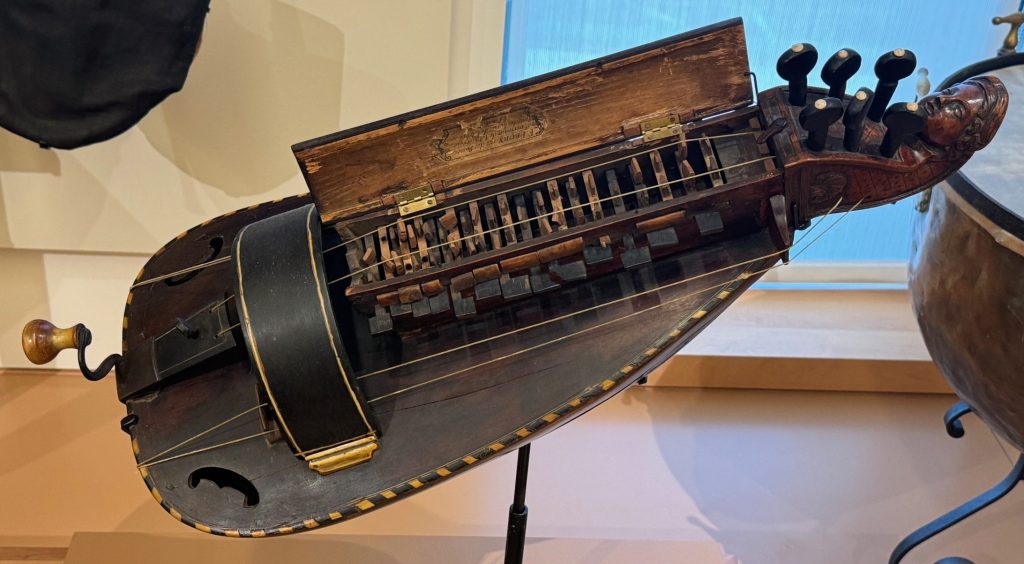 A musical instrument played by turning a crank handle and pressing on keys