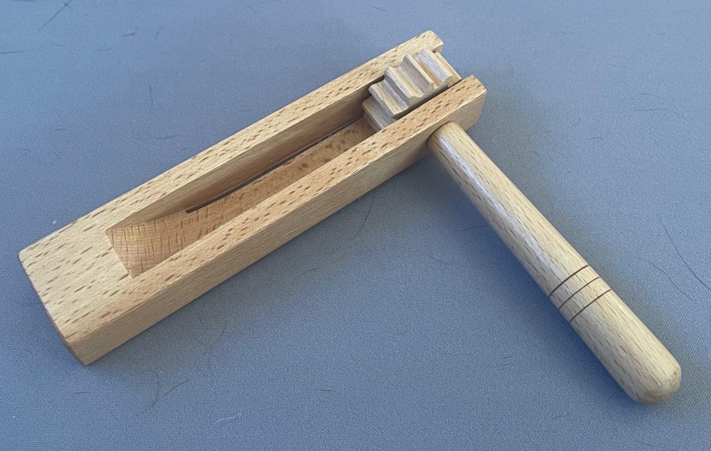spinning instrument with cogged wheel for making rattling noise.